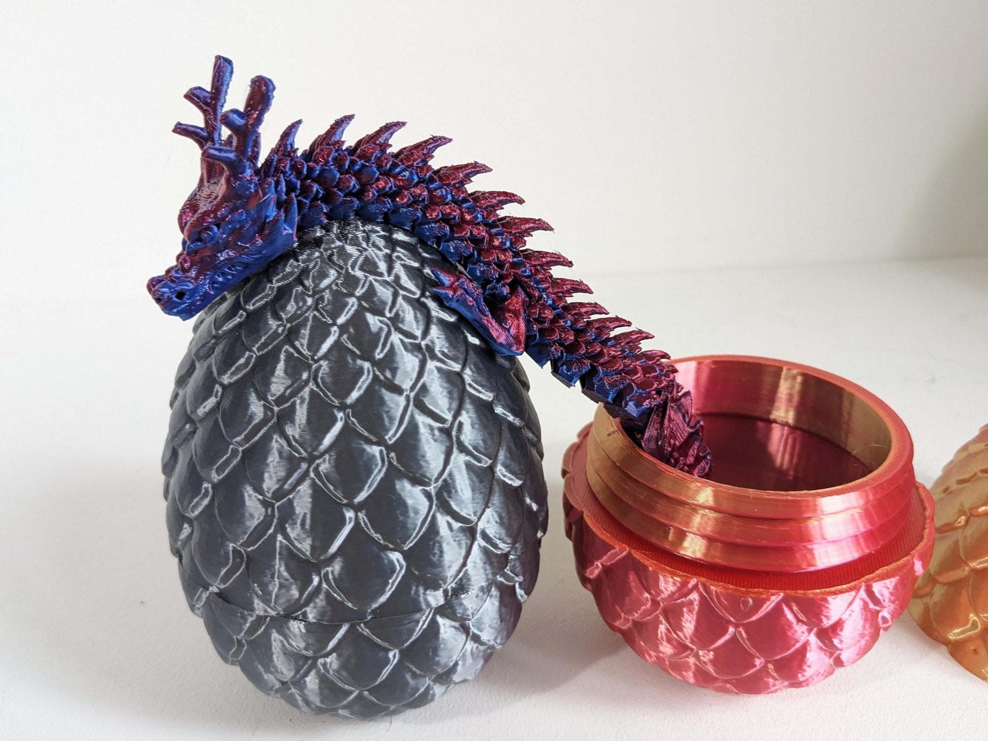 Articulated Crystal slinky Dragon 3d printed horned fidget toy. Three sizes with or without egg. UK made top quality.