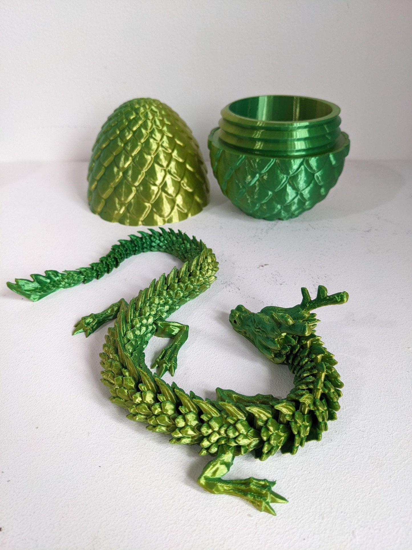 Articulated Crystal slinky Dragon 3d printed horned fidget toy. Three sizes with or without egg. UK made top quality.