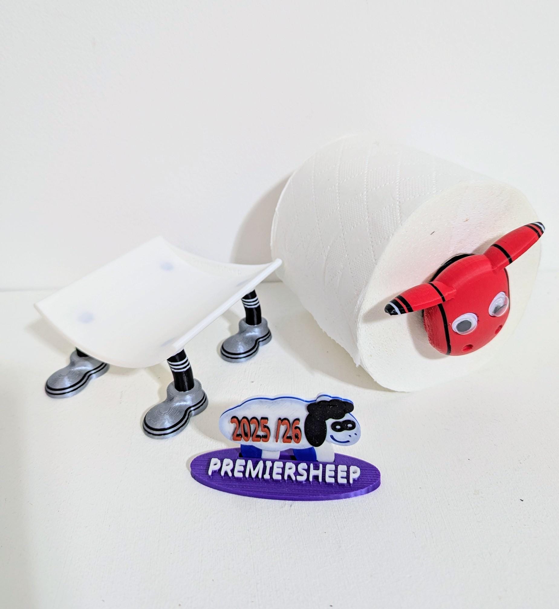 Manchester Utd Premier Sheep 2025 spare toilet roll holder or tissue dispenser cwith customised choice of Man united football boots.